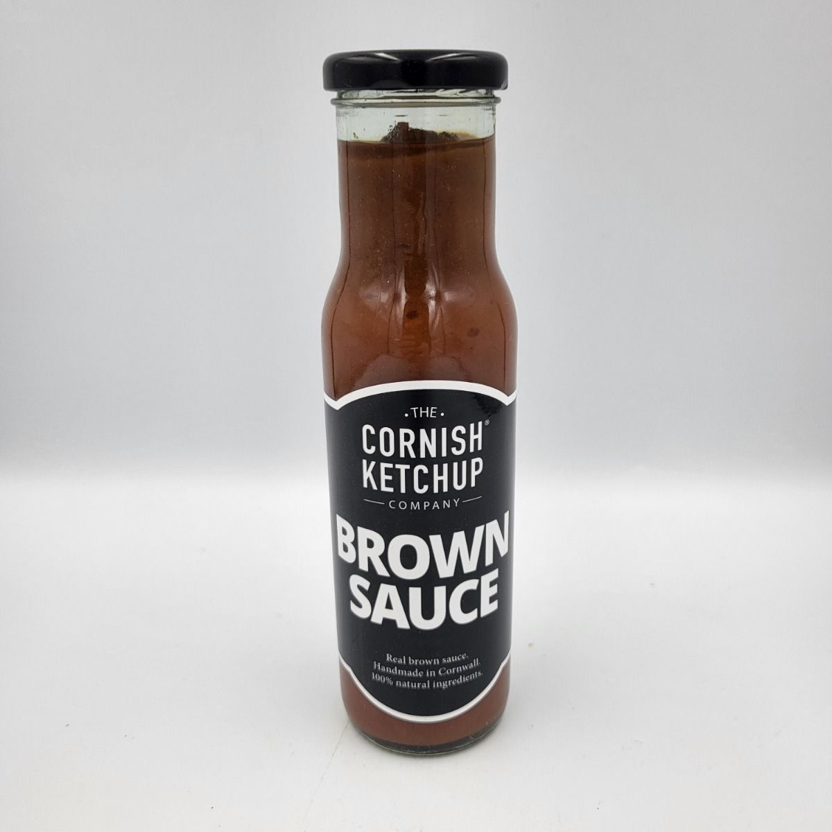 Cornish Ketchup bottle featuring a rich brown sauce with a glossy finish, labeled with 'The Cornish Ketchup Company' branding, set against a clean white background.