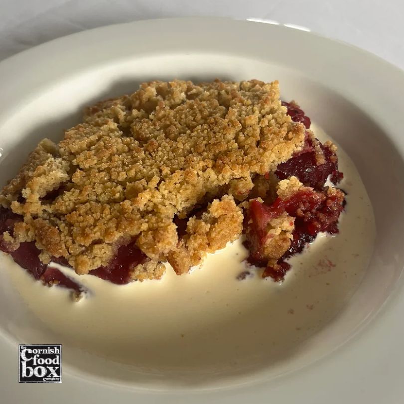 Homemade Cornish apple and blackberry crumble with golden buttery topping, ready to bake dessert