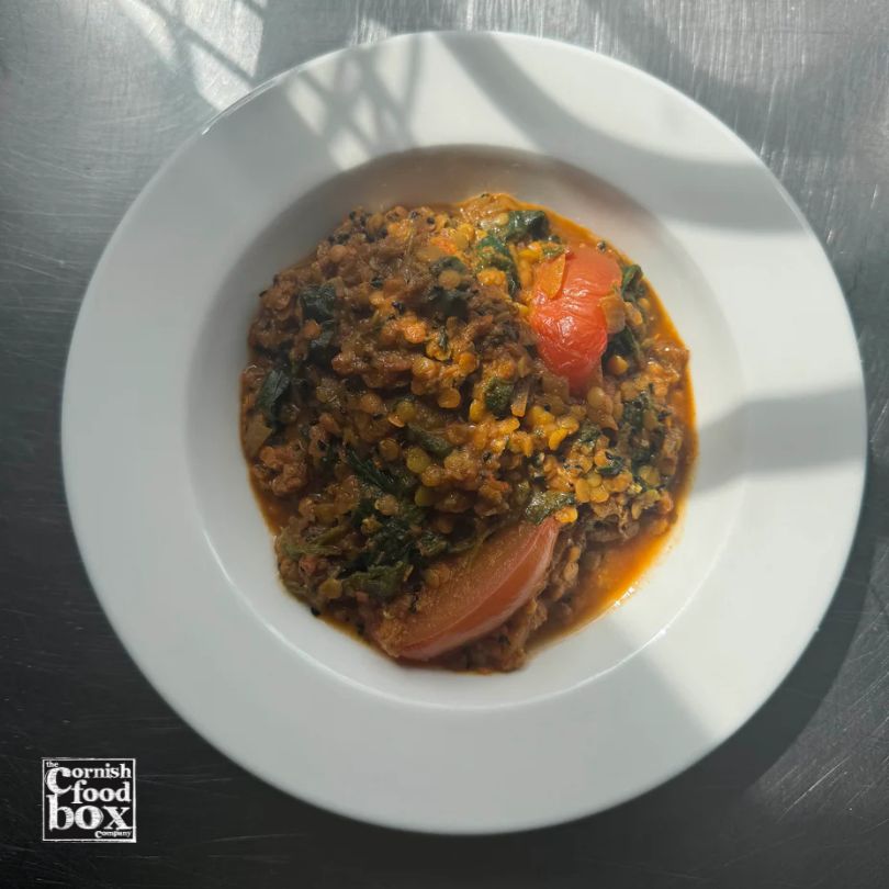 Handmade vegan red lentil dhal ready meal with tomatoes and spices, prepared in Cornwall